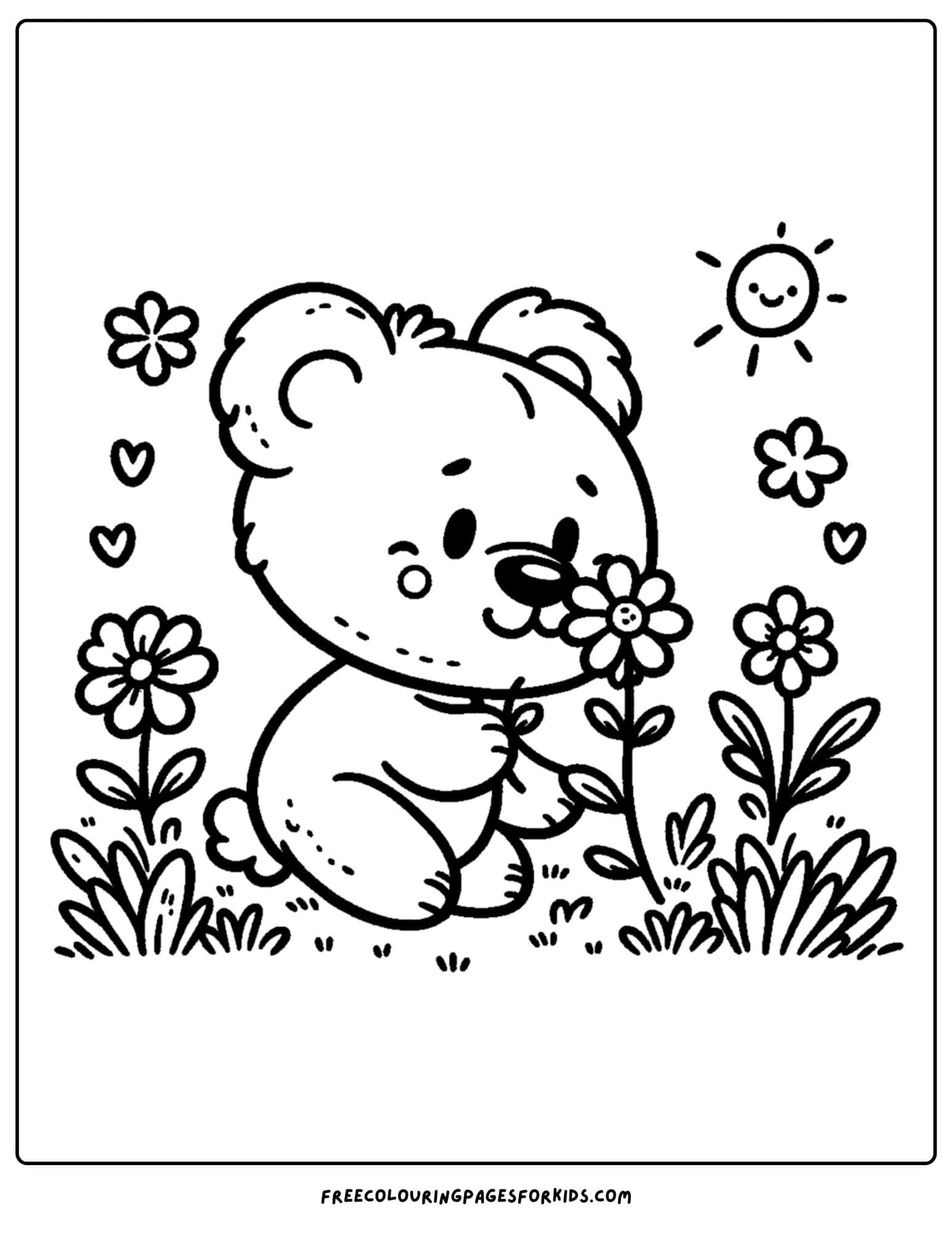 a bear smelling flowers