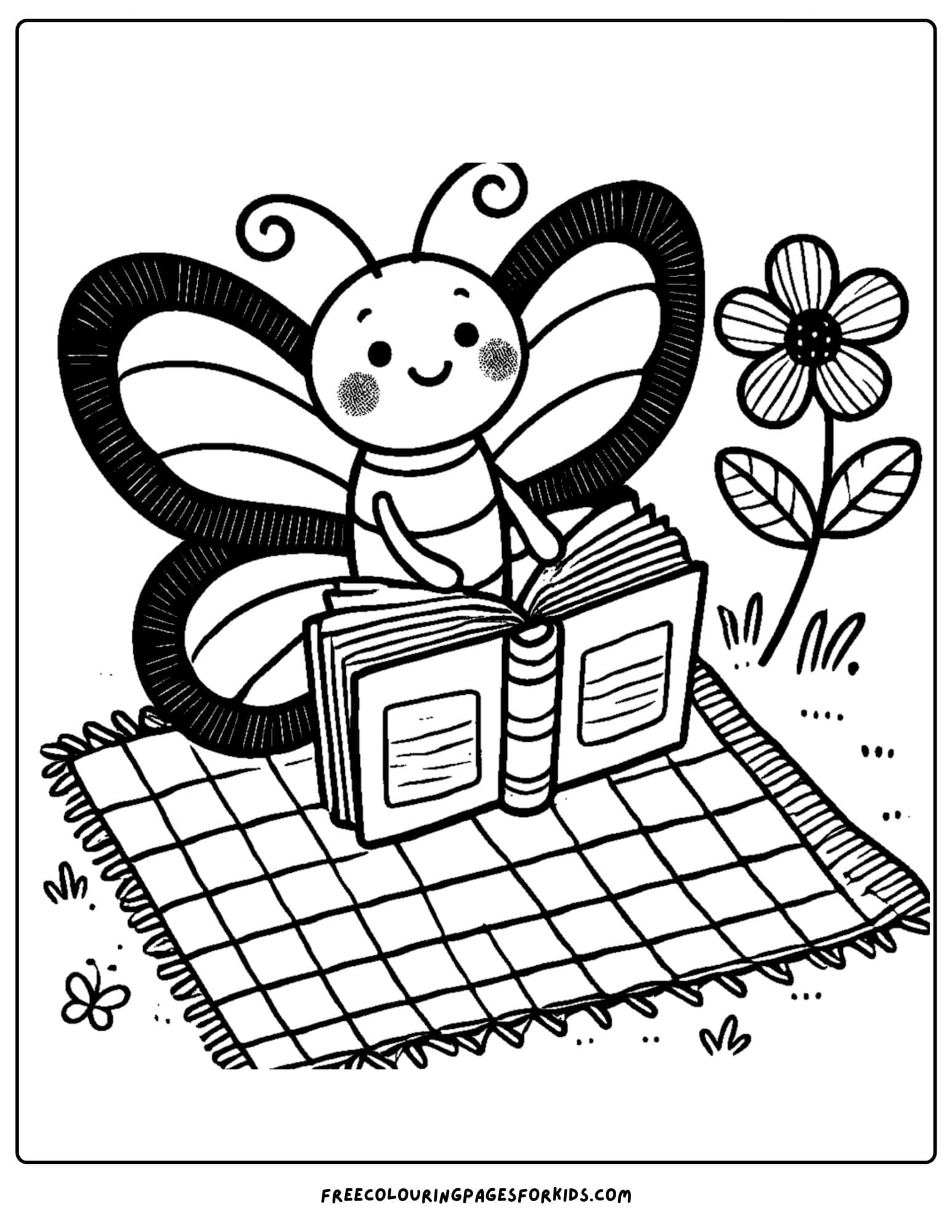 a butterfly reading on a picnic blanket