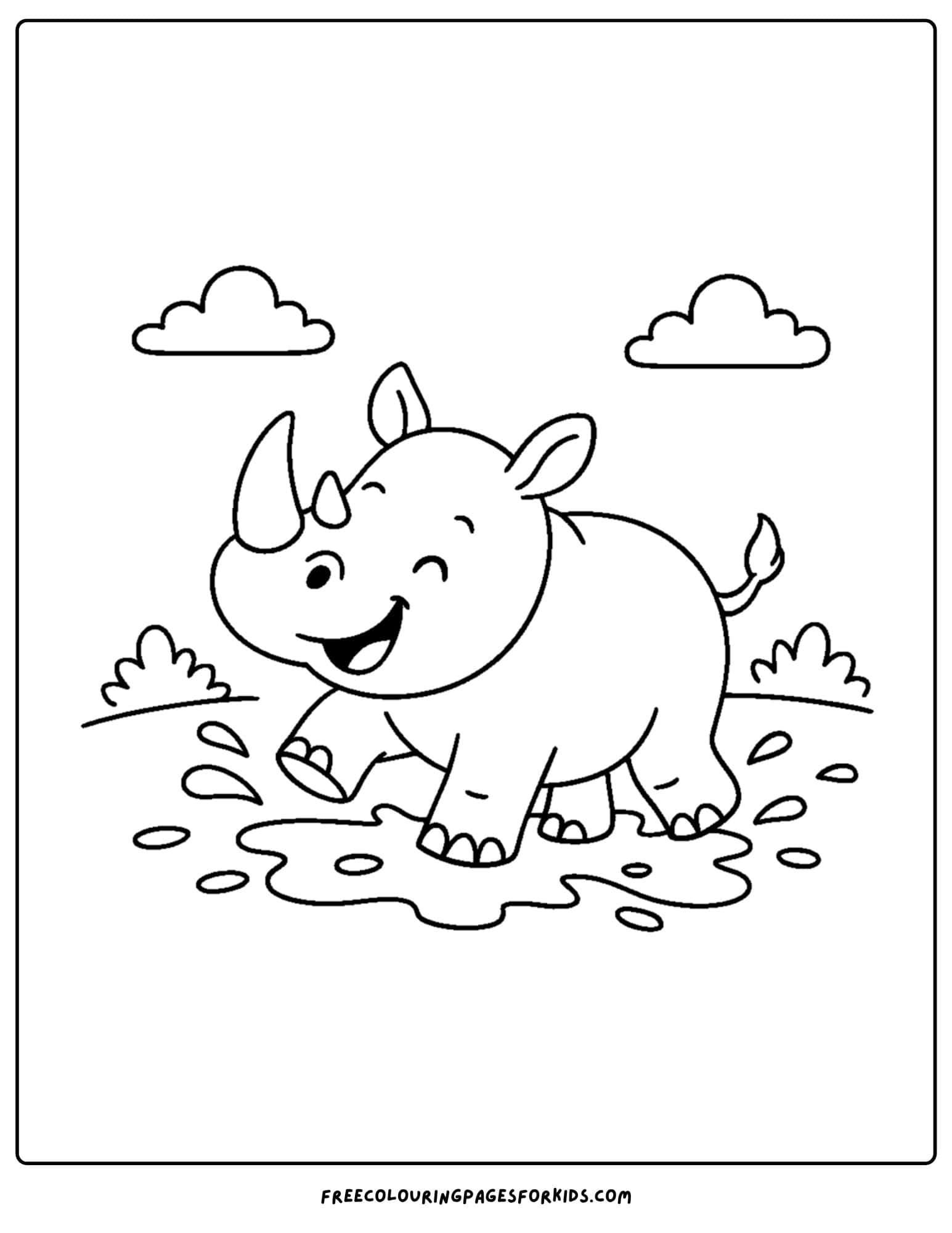 a rhino splashing in the mud